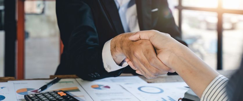 Business people shaking hands during a meeting in the office, success, dealing, greeting and partner concept