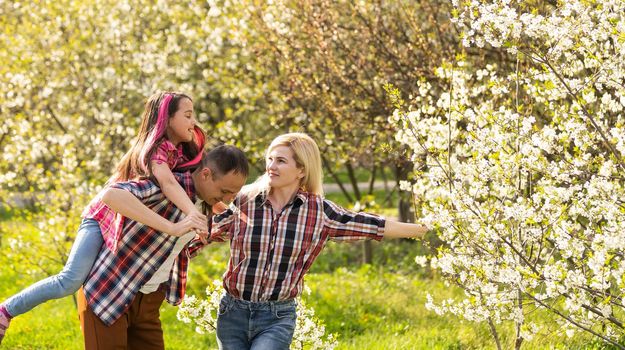 Young family with child having fun in nature.