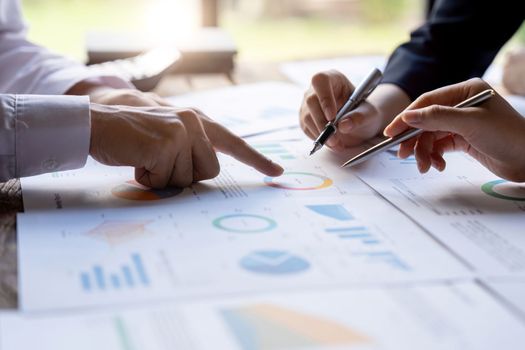 Business People Meeting to analyse and discuss and brainstorming the financial report chart data in office Financial advisor teamwork and accounting concept. Close up shot.