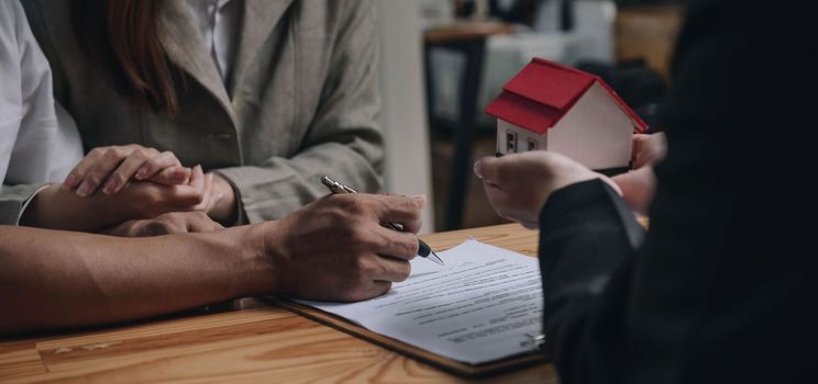 Discussion with a real estate agent, House model with agent and customer discussing for the contract to buy, get insurance or loan real estate or property..