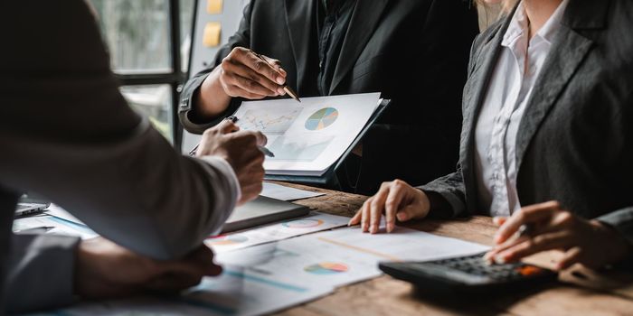 Startup business meeting to analyze and discuss the situation on the financial report in the meeting room. Investment Consultant, Financial advisor and accounting concept.