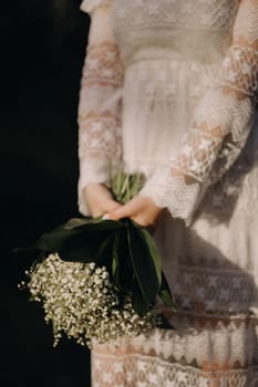 Close-up of lilies of the valley holding in the hands of a girl. Spring flowers