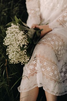 Close-up of lilies of the valley holding in the hands of a girl. Spring flowers