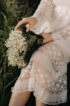 Close-up of lilies of the valley holding in the hands of a girl. Spring flowers