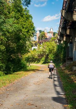 Cyclist riding along the rail trail in the downtown area of Morgantown WV towards the campus of West Virginia University