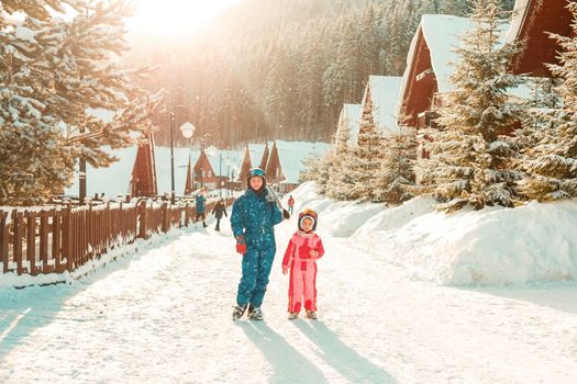 Winter, ski - Little girl with mother in ski resort