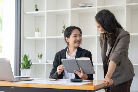 business administrator negotiation discussing about investment data spreadsheets in modern office.
