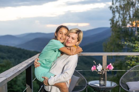 Photo of sweet charming mommy daughter hugging smiling.