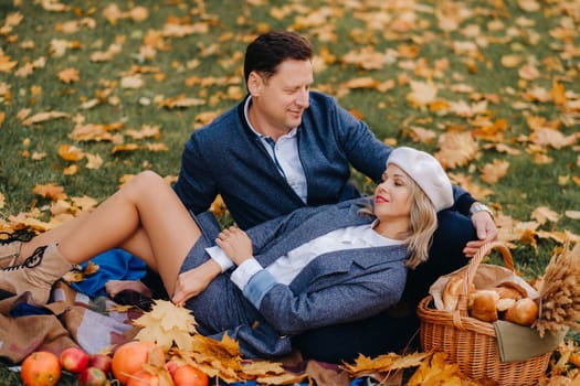 Happy couple enjoying golden autumn spring season in the park.