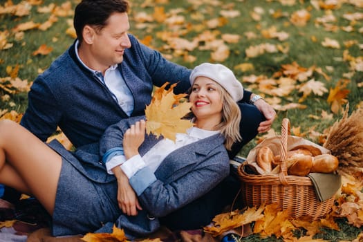 Happy couple enjoying golden autumn spring season in the park.