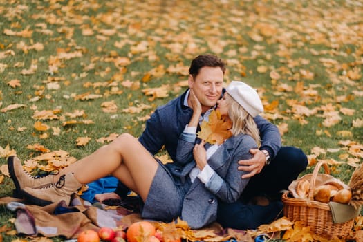 Happy couple enjoying golden autumn spring season in the park.