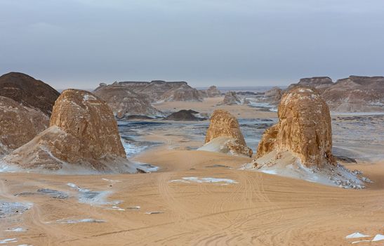 Landscape scenic view of desolate barren western desert in Egypt Valley of Agabat Obstacles at Farafra Oasis with geological rock formations