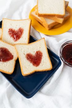 Toast on which the heart is made of jam. Surprise breakfast concept in bed. Romance for St. Valentine's Day