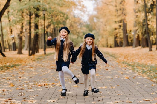 Happy children are running in a beautiful autumn park.