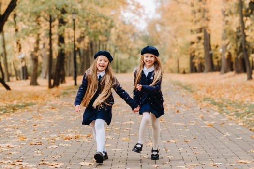 Happy children are running in a beautiful autumn park.