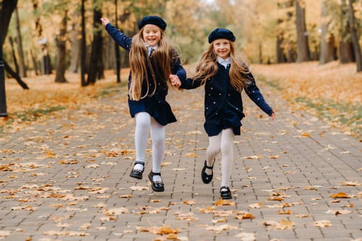 Happy children are running in a beautiful autumn park.