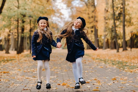 Happy children are running in a beautiful autumn park.