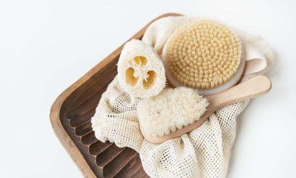 Zero waste, sustainable bathroom and lifestyle. Bamboo brush,, loofah sponge, cactus massage brush on a white background. Zero waste concept