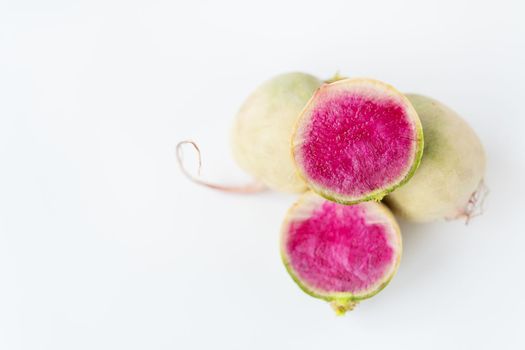 Delicious pink radish in the cut of the dragon's eye variety on a white background