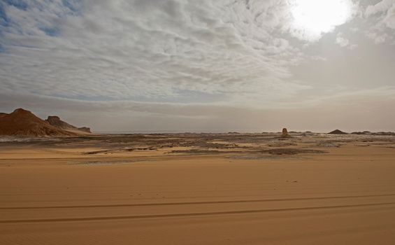 Landscape scenic view of desolate barren western desert in Egypt with sand dunes and rocky mountain