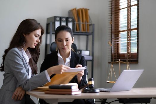 business people and lawyers discussing contract papers sitting at the table. Concepts of law, advice, legal services, legal and judgment concept.