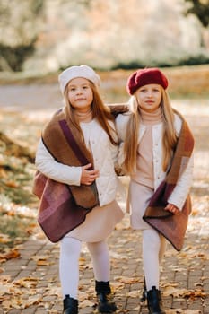 Happy children cuddling in a beautiful autumn park.