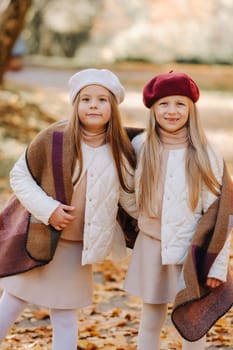 Happy children cuddling in a beautiful autumn park.