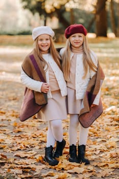 Happy children cuddling in a beautiful autumn park.