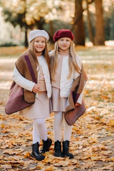 Happy children cuddling in a beautiful autumn park.