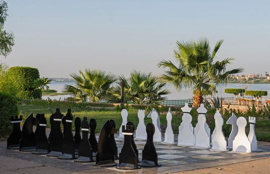 Large chess set game outside in outdoor games area at luxury hotel resort with nile river view background