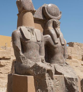 Pair of large seated statues in ancient egyptian Mediant Habu Temple at Luxor