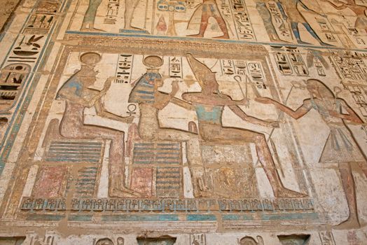 Hieroglypic carvings on wall at the ancient egyptian Medinat Habu Temple in Luxor Egypt