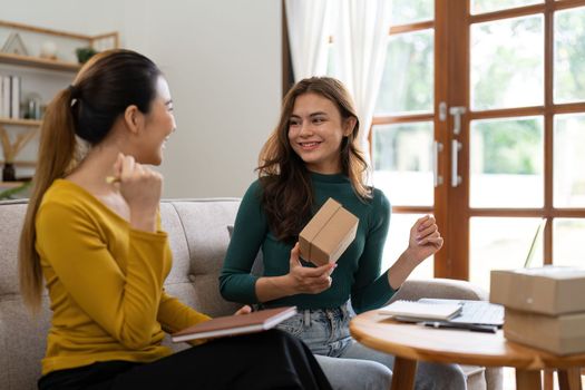 Two women busines startup for online marketing, Entrepreneur packing boxes parcels for shipping, SME sellers, and freelance online sales concept.