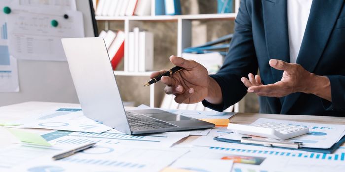 Close up a man working about financial with calculator at his office to calculate expenses, Accounting tax concept...