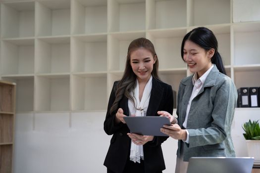 diverse coworkers working together in boardroom, brainstorming, discussing and analyzing and planning business strategy