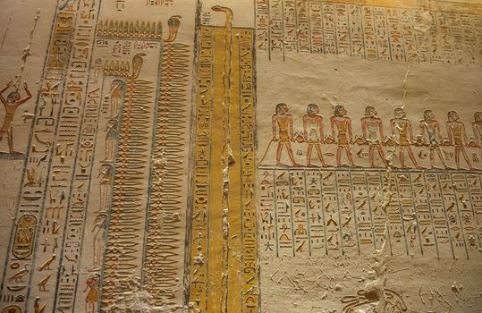Hieroglypic carvings on wall in the ancient egyptian tomb of ramses V and VI in Luxor Valley of the Kings