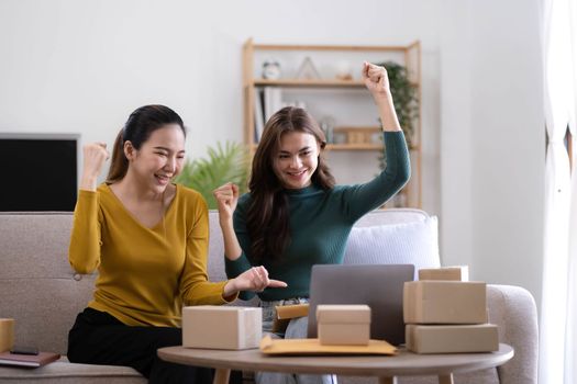 Portrait of Starting small businesses SME owners, two Asian woman check online orders Selling products working with boxs freelance work at home office, sme business online small medium enterprise.