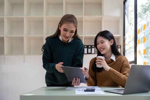 Asian business meeting to analyze and discuss the situation on the financial report in the meeting room. Investment Consultant, Financial advisor and accounting concept.