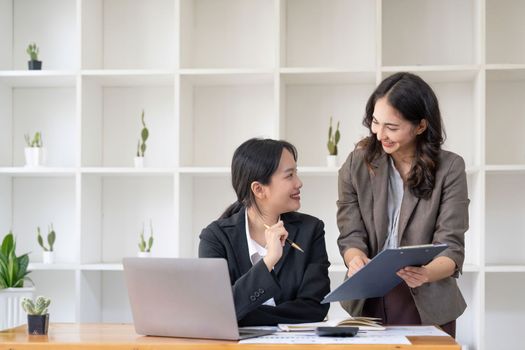 Asian business adviser meeting to analyze and discuss the situation on the financial report in the meeting room.Investment Consultant, Financial advisor and accounting concept.