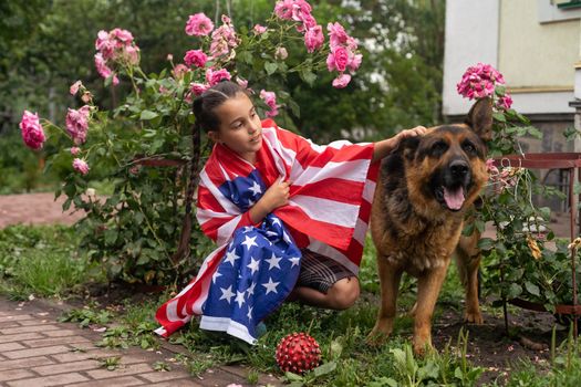 Happy little girl patriot running in the field with American flag. USA celebrate 4th of July. High quality photo