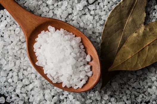 Sea salt and herbs bay leaf on the kitchen table. top view