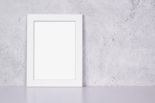 Mockup white frame vertical on table top and wall at home, mock up poster for presentation on desk, your design for gallery photo and picture image, border template and decoration for advertising.