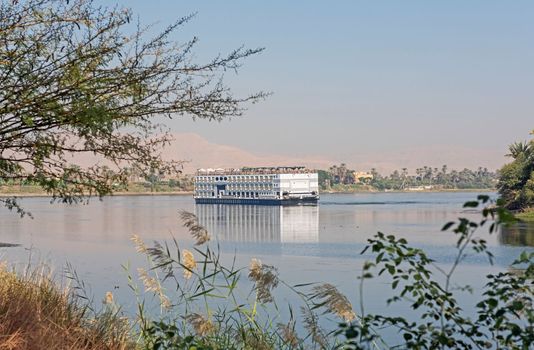 Large luxury traditional Egyptian river cruise boat sailing on the Nile