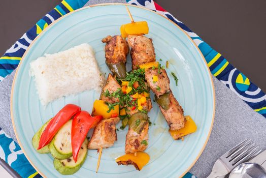 Chicken shish kebab a la carte meal with steamed white rice at restaurant table place setting