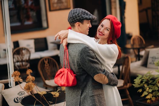 Portrait of a happy couple hugging on the street in an autumn city. Retro stylish couple in autumn in the city.