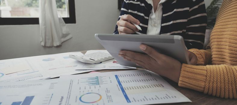 Businesswoman holding pens and holding graph paper are meeting to plan sales to meet targets set in next year