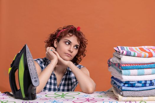 A girl glances at the ironed towels. A woman with big beautiful eyes. It's time to relax after doing the daily work at home.