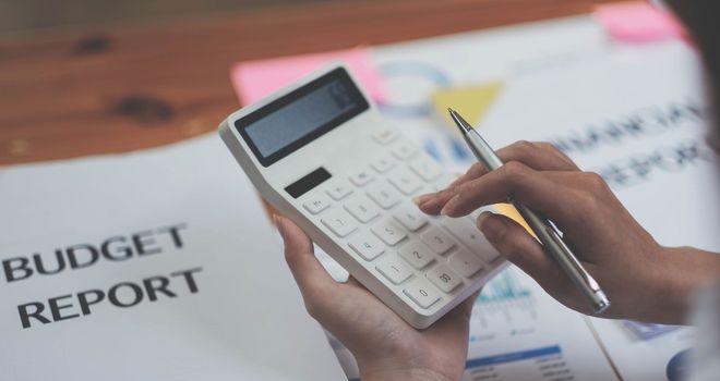 Close up Business woman using calculator for do math finance on wooden desk in office and business working background, tax, accounting, statistics and analytic research concept.