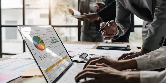 Asian business adviser meeting to analyze and discuss the situation on the financial report in the meeting room.Investment Consultant,Financial Consultant,Financial advisor and accounting concept.