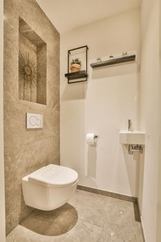 a white toilet in a bathroom with a mirror on the wall above it and an open door leading to another room